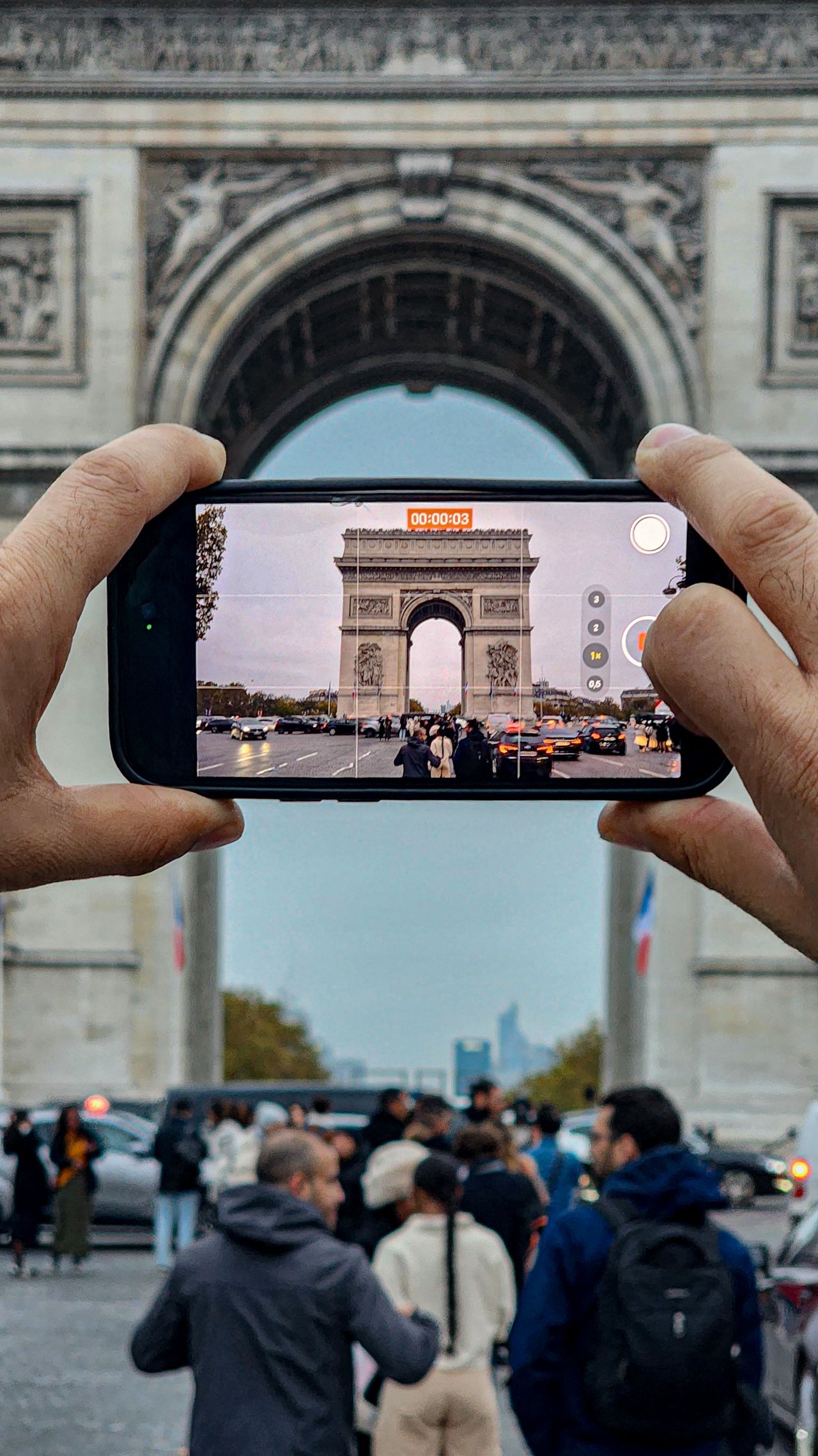 Taking a photo of the Arc de Triomphe in Paris